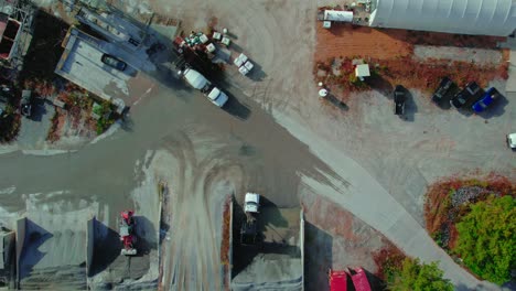 aerial view of ready mix cement supplier with mixer trucks loading wet concrete