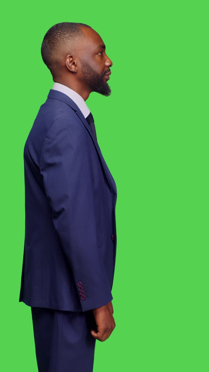 Vertical video: Profile of confident businessman in suit working on corporate job