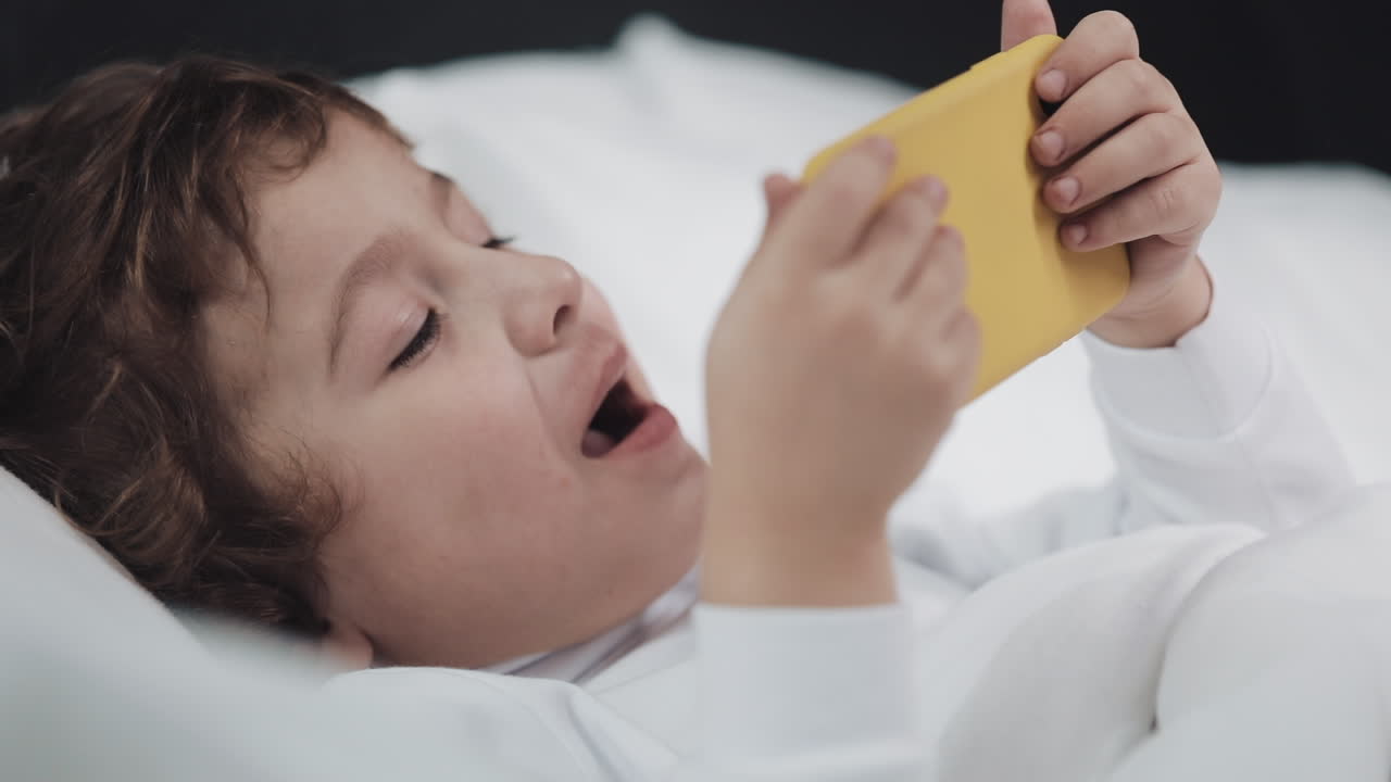 Child playing with phone
