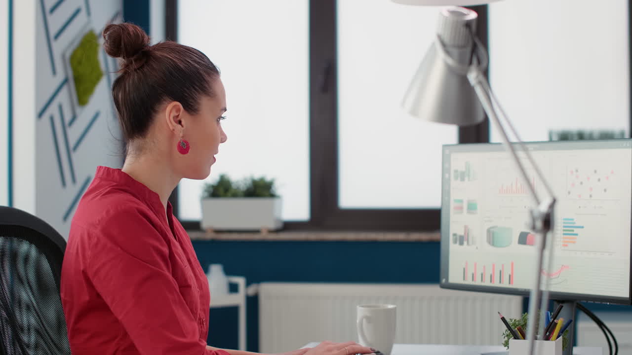 Female employee working with financial statistics on diagrams