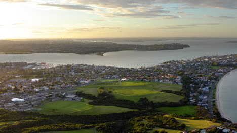 panoramic aerial view of a coastal city at sunset