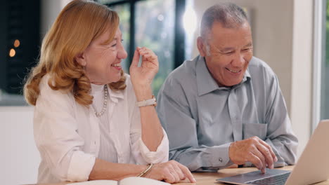 senior couple using laptop together