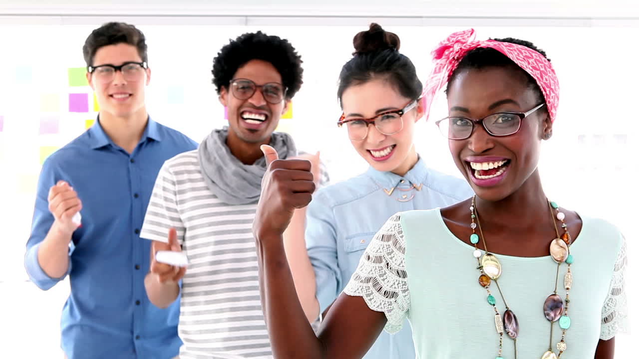 Creative business team showing thumbs up