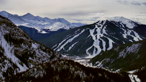 distant i70 copper mountain leadville colorado winter december christmas aerial drone cinematic landscape silverthorne vail aspen ten mile range cloudy rocky mountains upward reveal