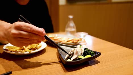 person enjoying a meal with chopsticks