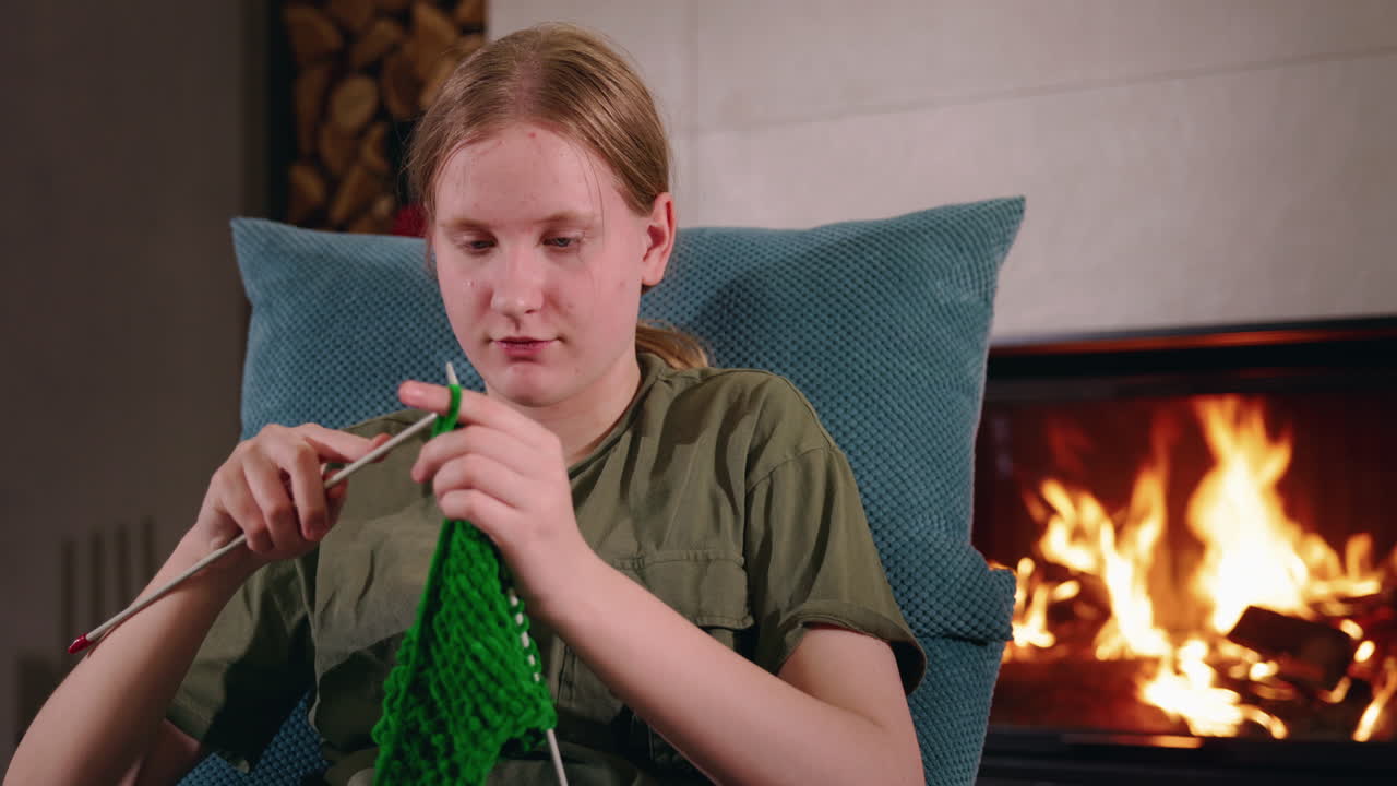 Teenage Girl Knitting by the Fireplace