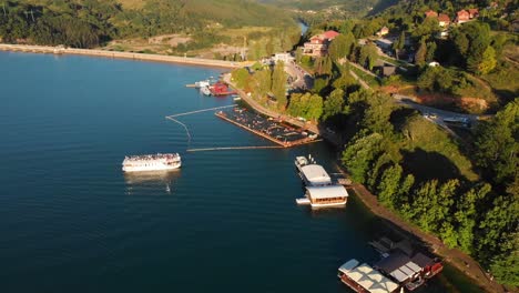 passenger boat cruising on perucac lake in serbia during sunset