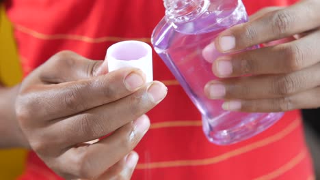 pouring mouthwash