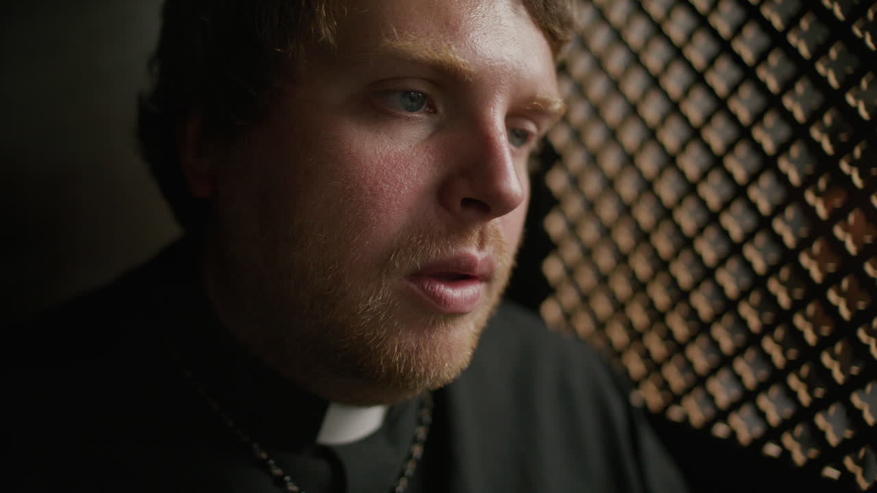 Priest Having Private Conversation with Penitent during Confessional Session