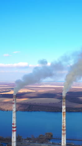 aerial view of smoking factory tubes. indusrty energy producing air pollution.
