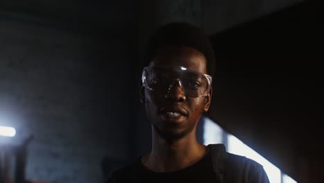 man in safety glasses in industrial setting