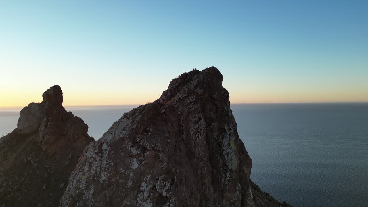 Aerial shot of people ascending a mountain