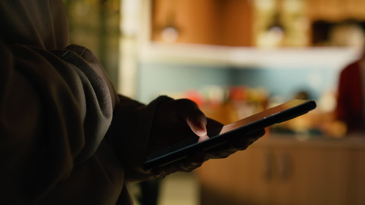 Adult black woman enjoying cozy moment at home and browsing apps