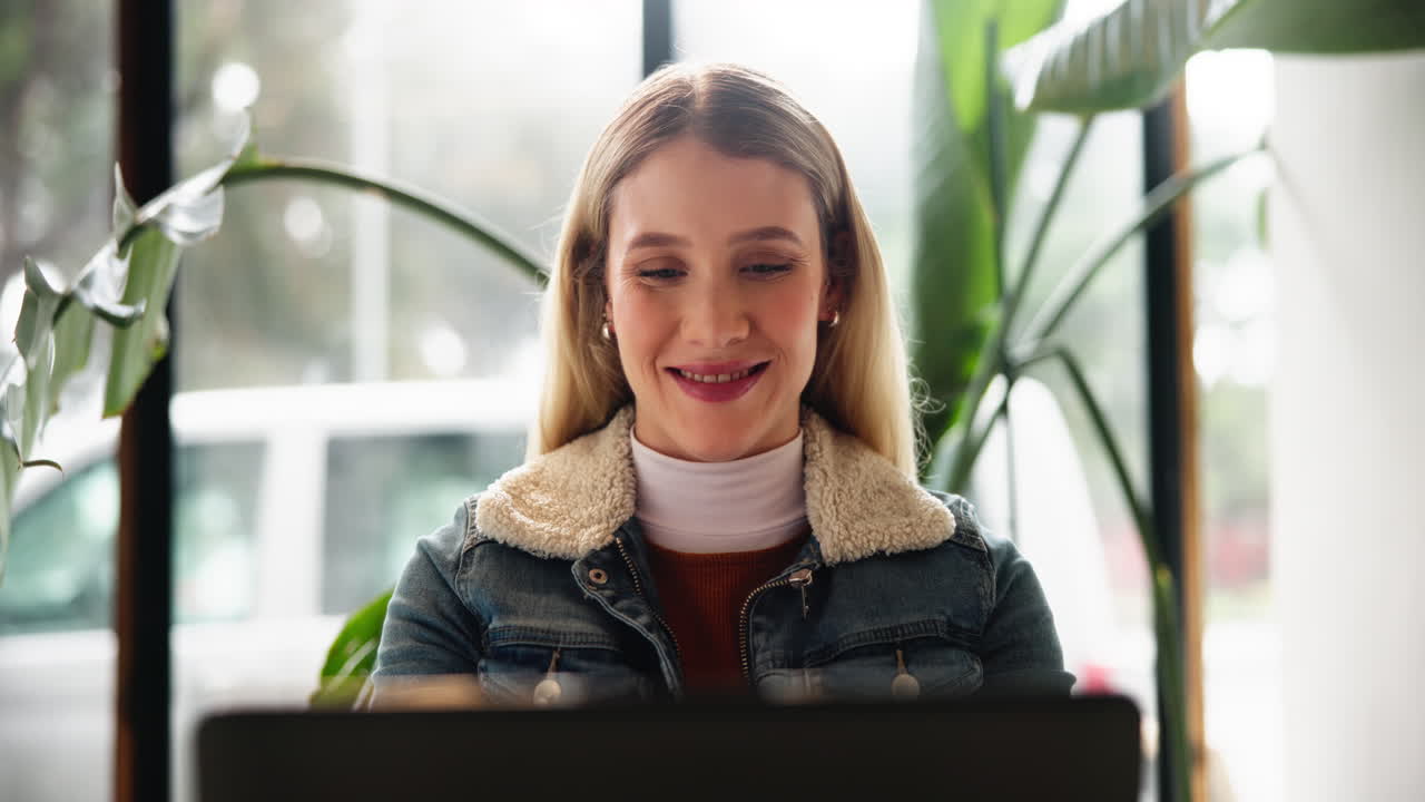 Woman working on laptop in office setting