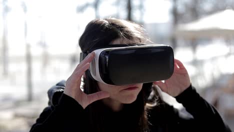 focused woman using vr headset on street