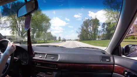 Hand-Of-Girl-Woman-Driving-A-Car-On-Highway-Freeway-In-USA-|-From-Passenger-Seat