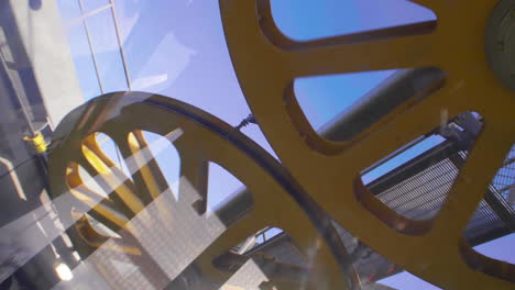 big yellow gears turning above montjuic cable car in barcelona in january