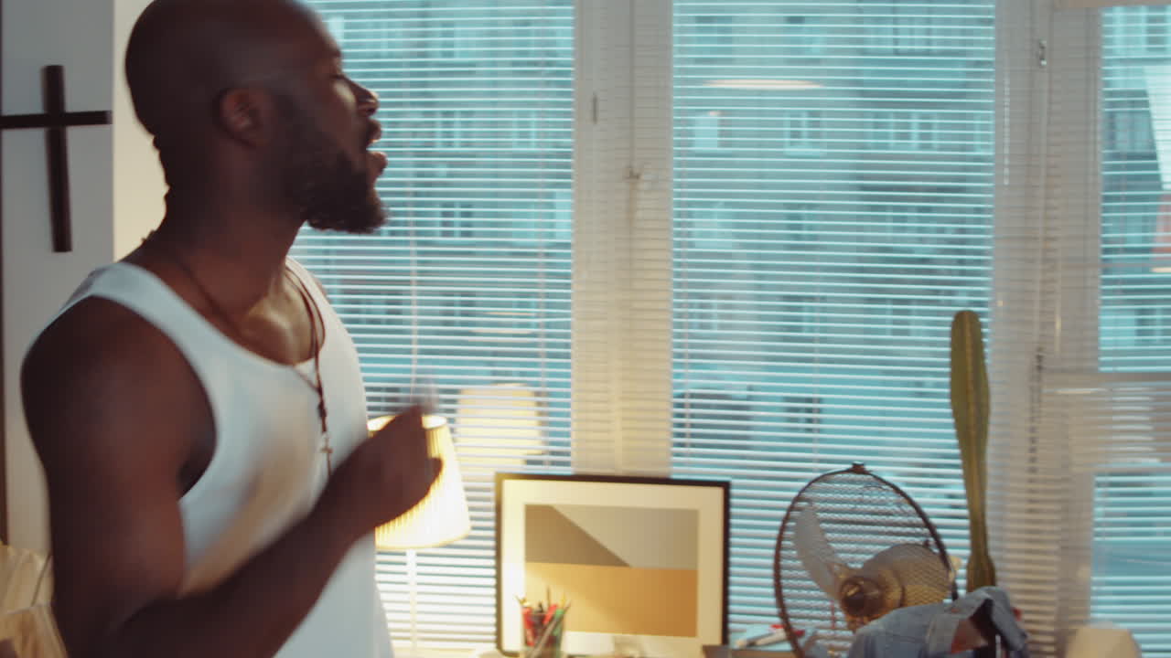 African American Man Dancing to Music on Cassette Player at Home