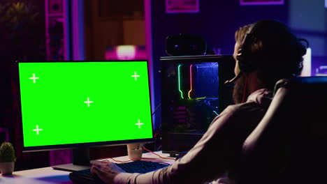 professional gamer using chroma key pc desktop to complete levels in game, talking with friends