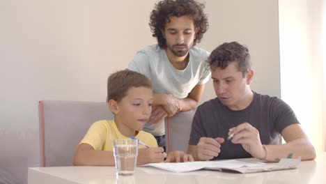 homosexual parents helping son with writing task