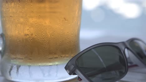 close up cold beer with sunglasses in a table, barcelona, spain, static shot