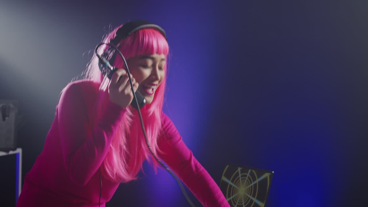Female DJ with Pink Hair Performing Music
