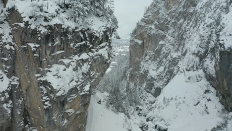 aerial of mountain ridge, revealing snow covered valley