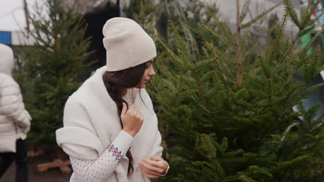 woman choosing a christmas tree