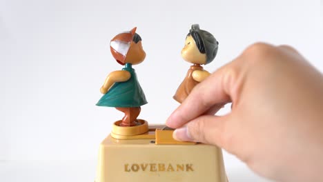 Love-story-antique-toy-of-cash-box,-2-kids-kissing,-romantic-and-cute,-isolated-on-white-background