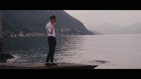 Man Smoking by the Lake