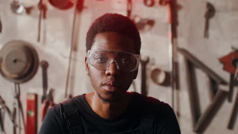 man wearing safety glasses in a workshop