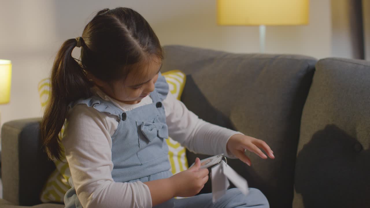 Girl On ASD Spectrum Being Helped Or Assessed By Female Teacher Or Educational Psychologist At Home With Feeling Cue Cards
