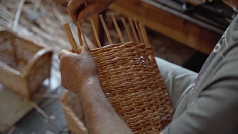 old man working with wicker medium shot