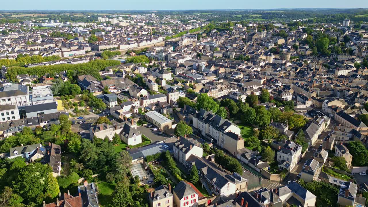 Backward drone Laval cityscape showing dense residential buildings on urban environment, Mayenne, France