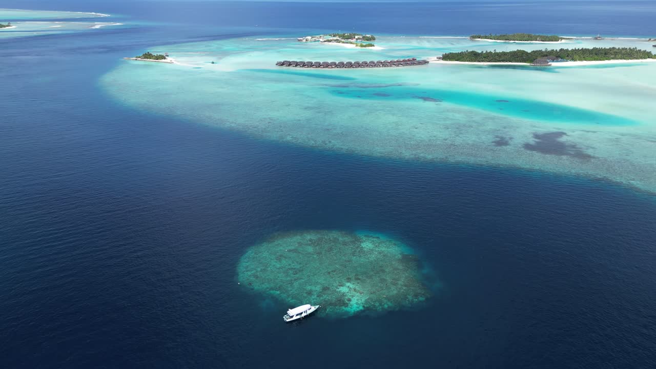 Aerial View of Luxurious Maldives Overwater Bungalows and Coral Reef