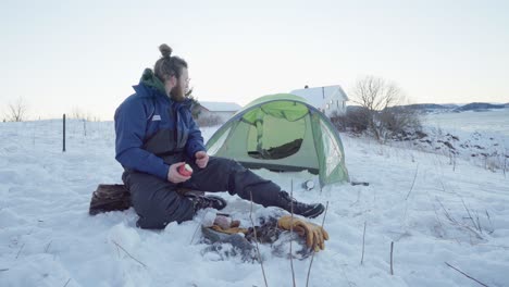 a man eating apple for breakfast at winter