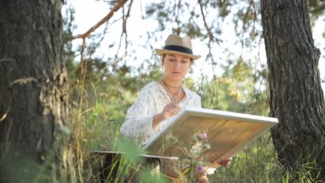 a young woman draws a picture of a pine forest at sunset - a young woman draws a picture of a pine forest at sunset. the artist admires the natural landscape, beautiful trees. leisure concept illustration