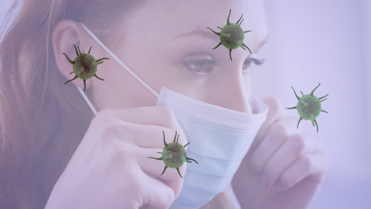múltiples células de covid-19 que se mueven contra el primer plano de una mujer caucásica que usa una máscara facial