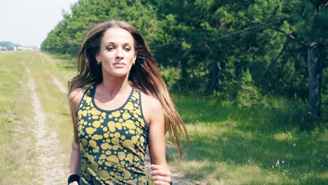 CU-Portrait-Young-girl-goes-in-for-sports-in-the-morning-runs-along-a-pine-forest-2