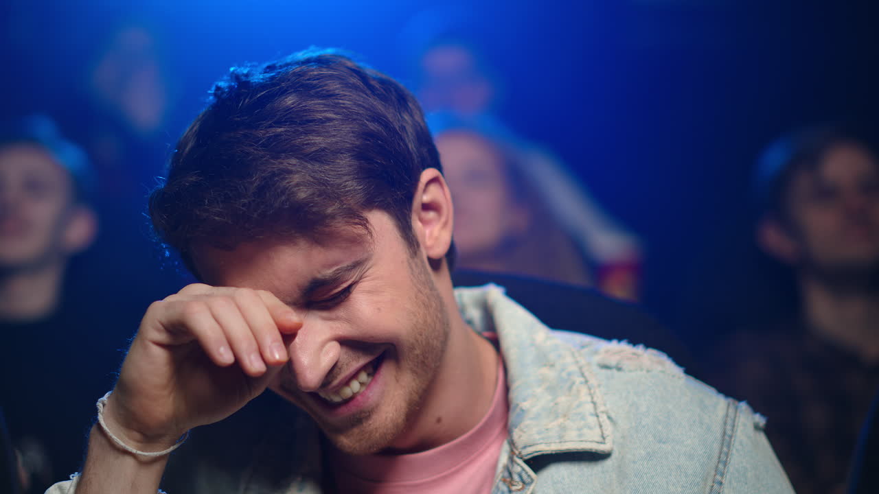 Happy guy laughing in cinema