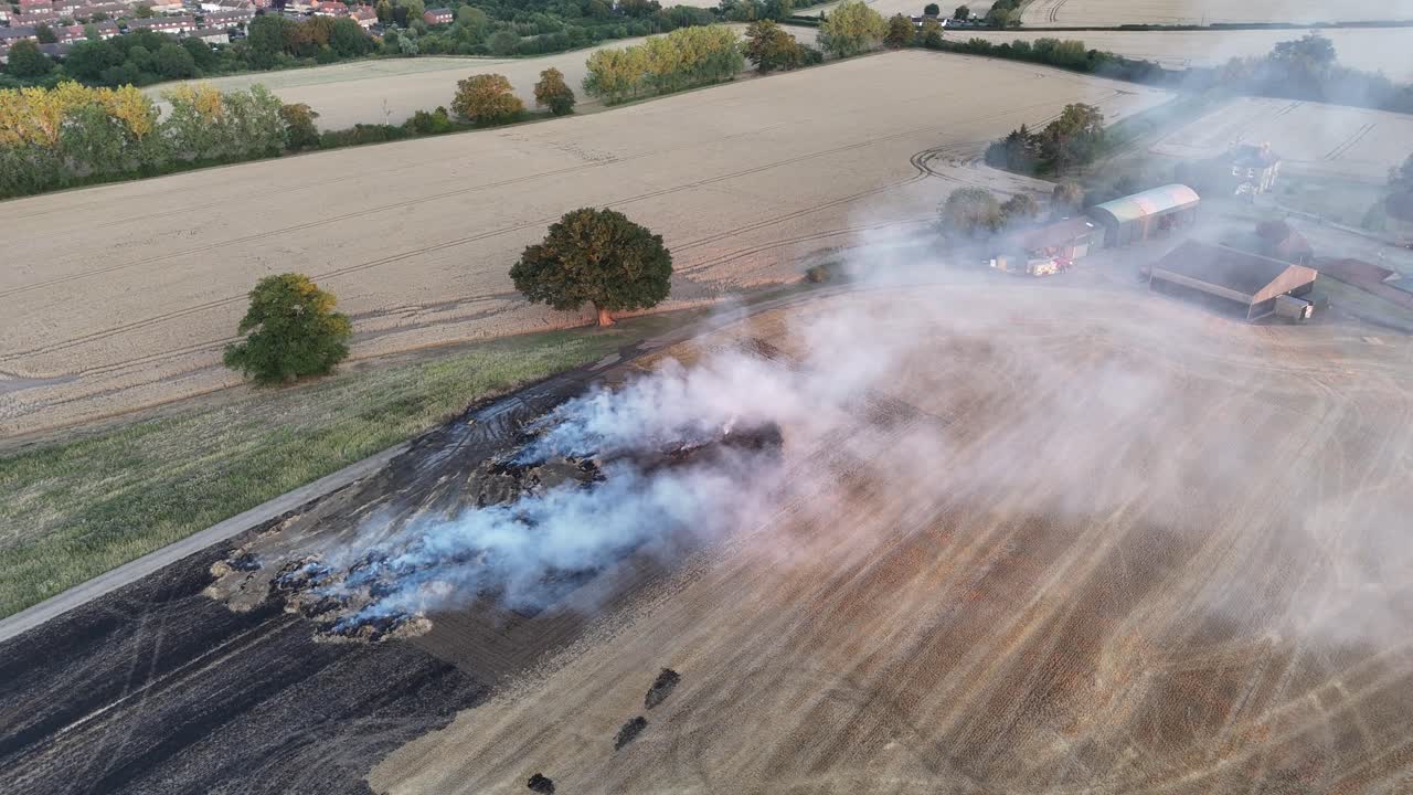 Farm Fields on Fire and smoking Essex UK fire engine attending hot sunset drone,aerial
