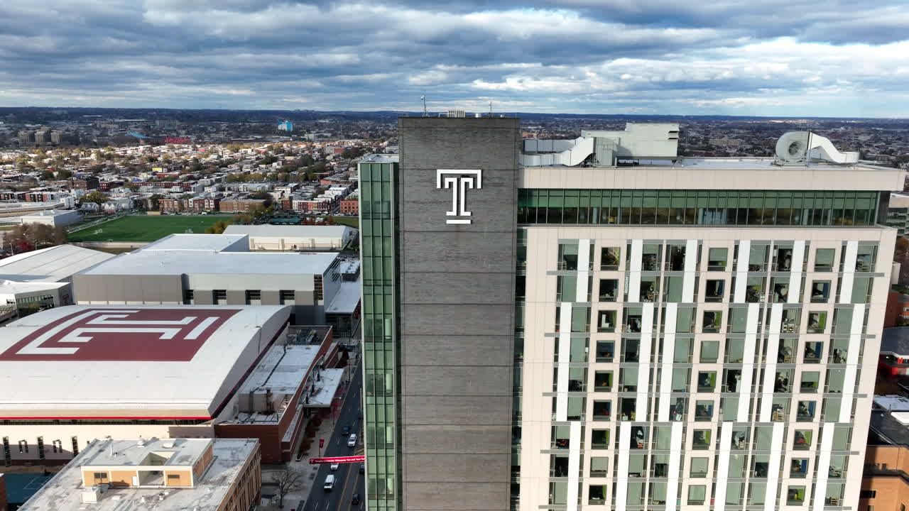 Temple University public research school in Pennsylvania. Aerial pullback reveal shot. Temple T.