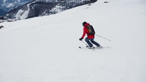 skier skiing down the slope making turns in slow motion