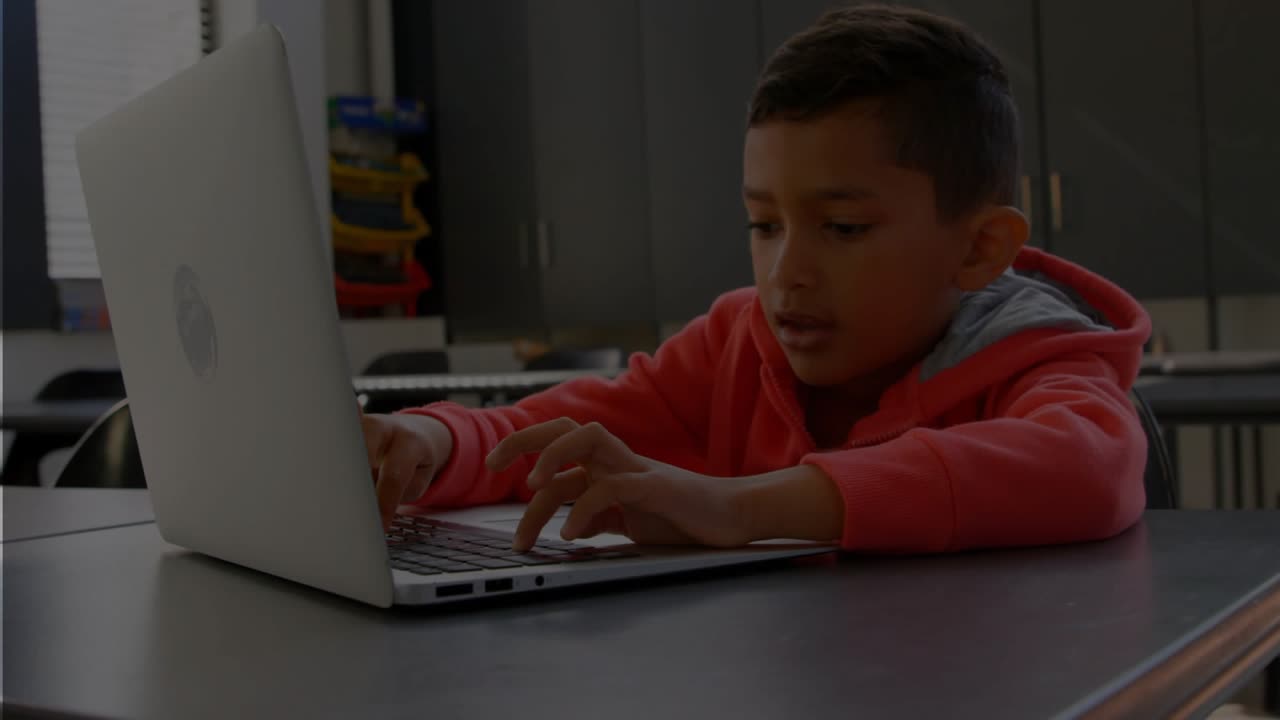 Student hovering then pressing keys on laptop, turquoise overlay showing keys during education work