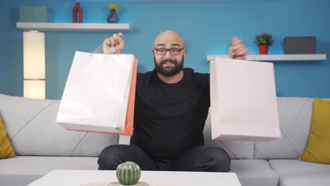 Man-looking-at-camera-with-shopping-bags.