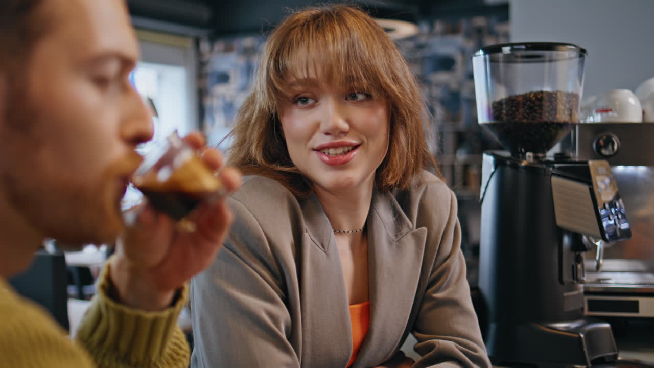 Talking coworkers drinking espresso at cafe closeup. Managers resting in bar