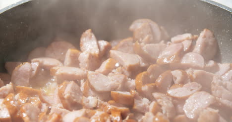 Sausages-Being-Fried-On-Pan