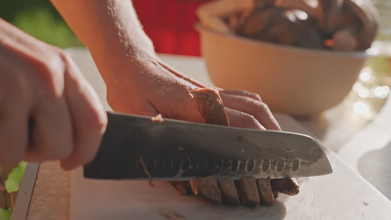 Caucasian hands slicing grilled meat campsite in warm afternoon sun, sharp knife and chopping board next to portable stove and bowl, quick rhythmic cuts for sandwiches and camp plates, energetic