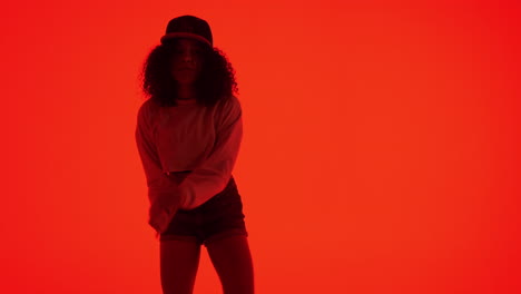 woman dancing in a red studio