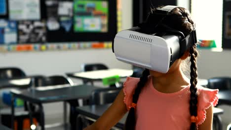 Schoolgirl-using-virtual-reality-headset-in-classroom-4k